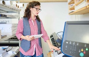 woman changing setting in printer