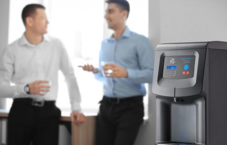 Office employees having break near water cooler