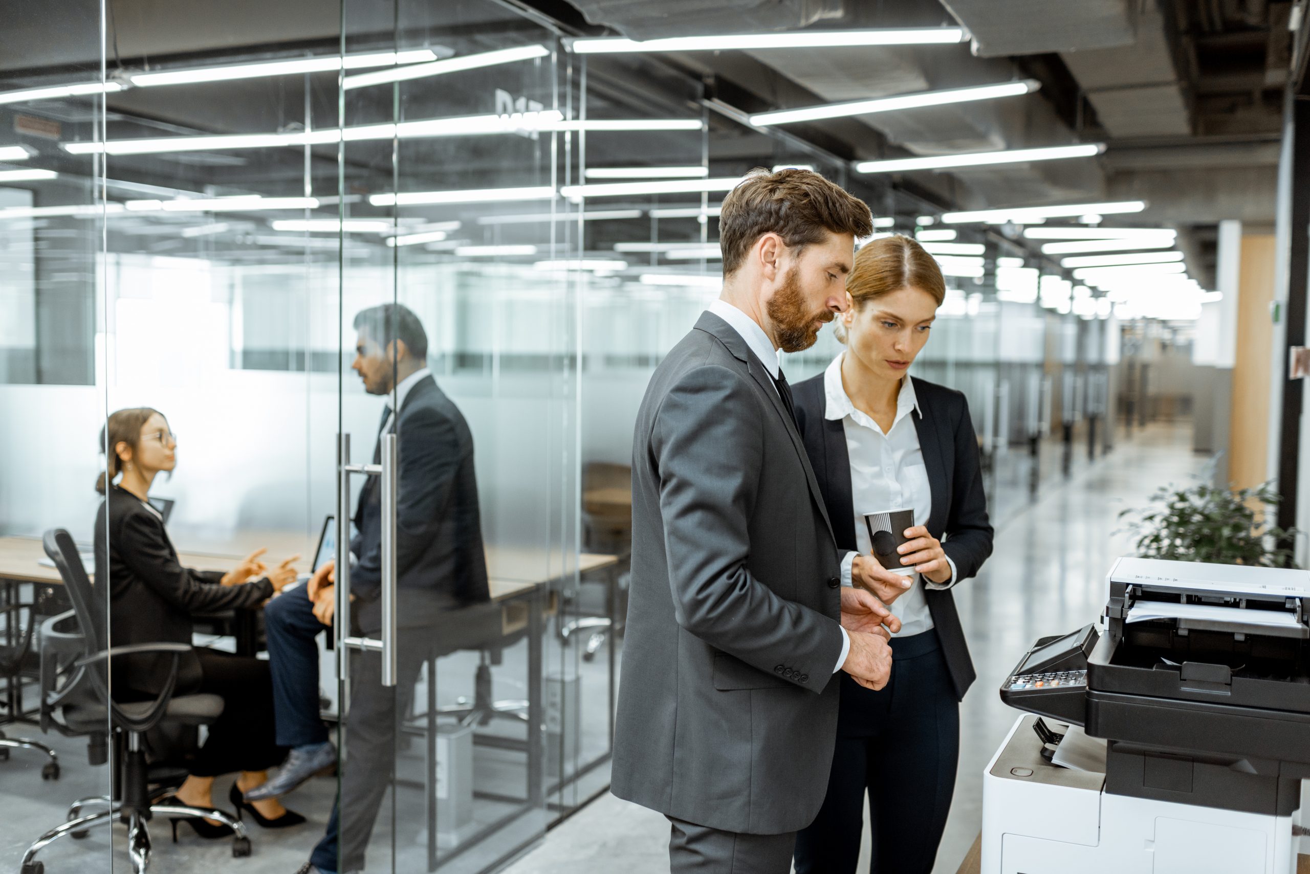 Business people near the copier in the hallway