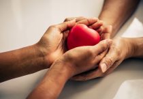 Helping hand of heart donor for patient in heart disease. Man give red heart to woman as couple. People lifestyle and couple romance. Healthcare and hospital medical concept. Symbolic of Valentine day