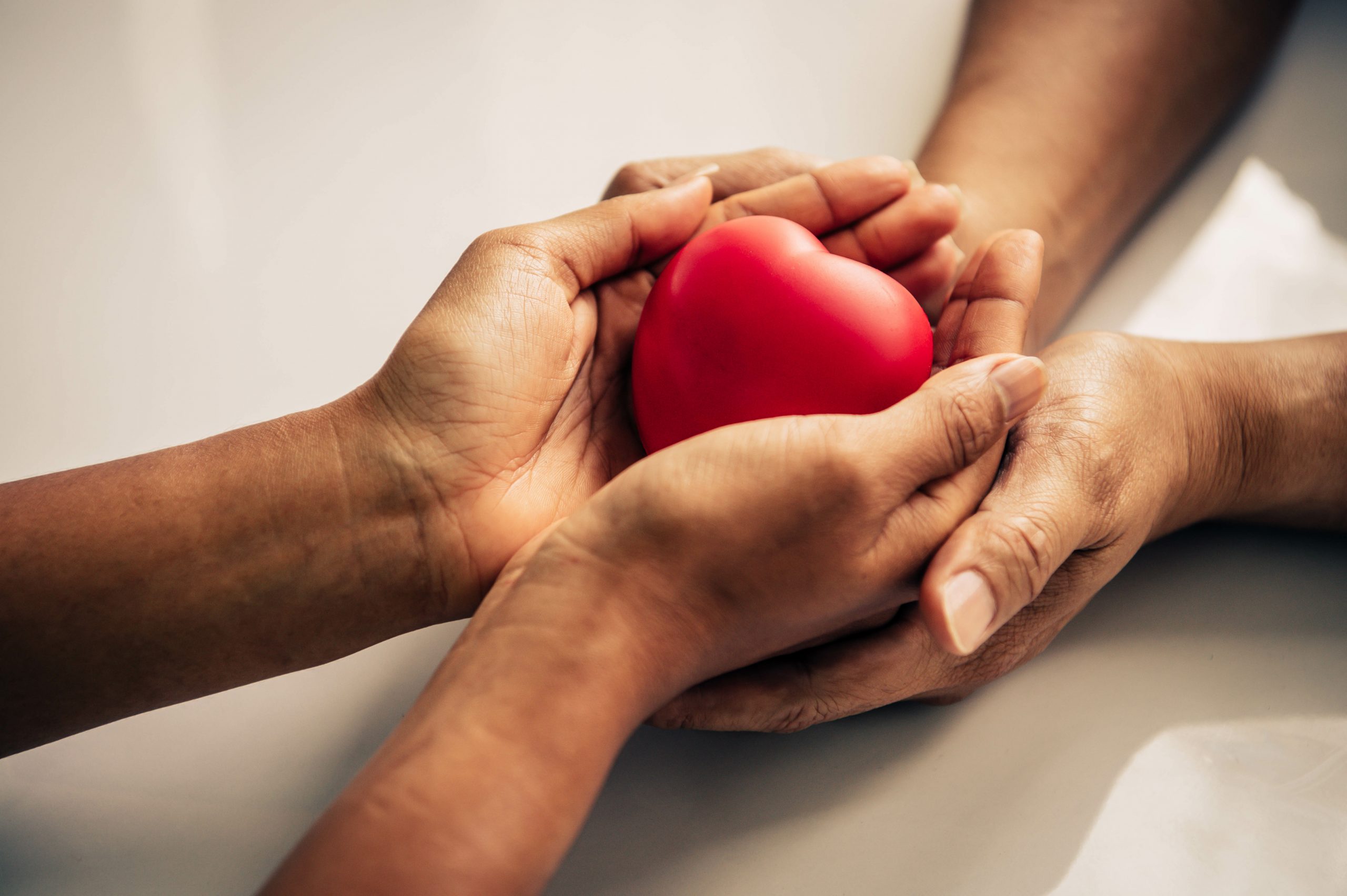 Helping hand of heart donor for patient in heart disease. Man give red heart to woman as couple. People lifestyle and couple romance. Healthcare and hospital medical concept. Symbolic of Valentine day