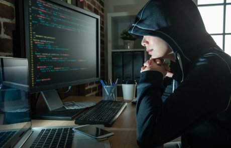 female hacker staring at the screen smiling.