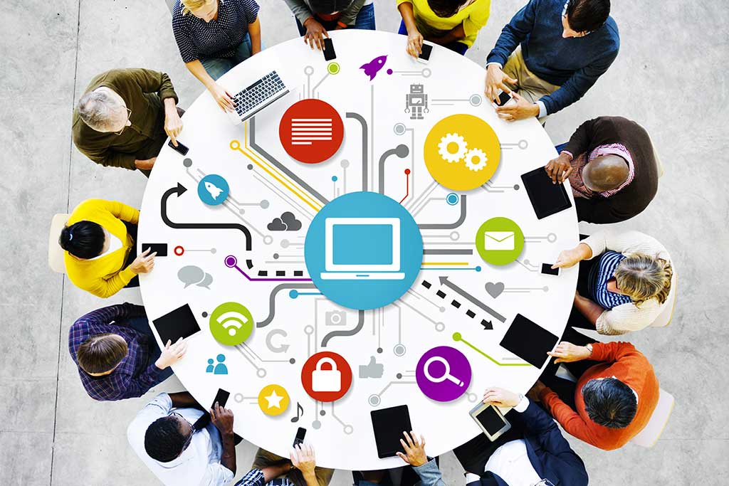 An image showing a team around table to showcase a reason for transitioning to managed VoIP services