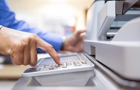 Printer brands: a man operating an office printer
