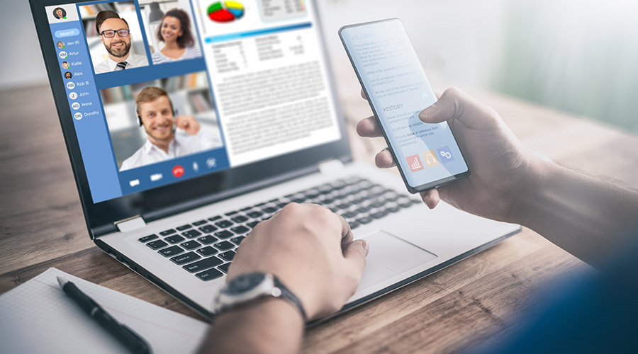 VoIP phone service: man using VoIP-powered conference call on his laptop