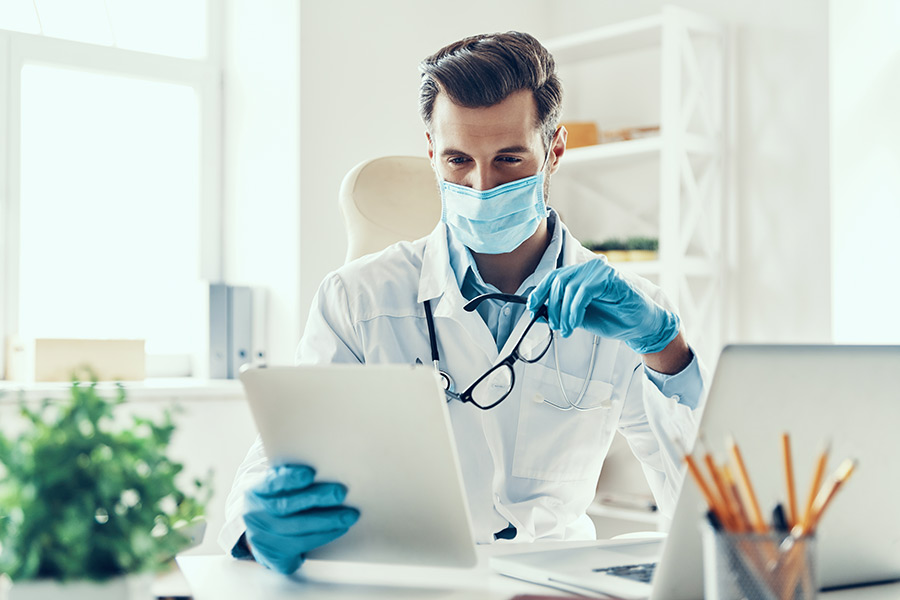 A doctor looking at patient's health records stored in HIPAA-compliant cloud server