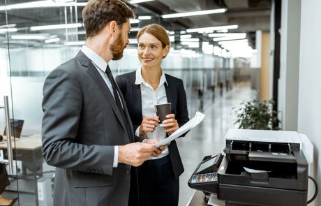 Man and woman in business suits discussing the costs and benefits of copier lease