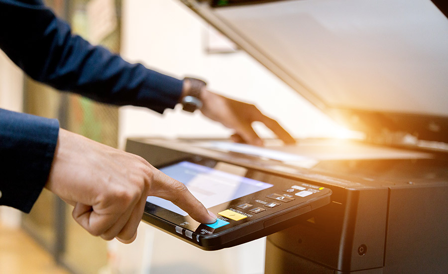 Man using a copier: hero image for Managed print solutions blog