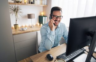 Man using his VoIP solution at a home office