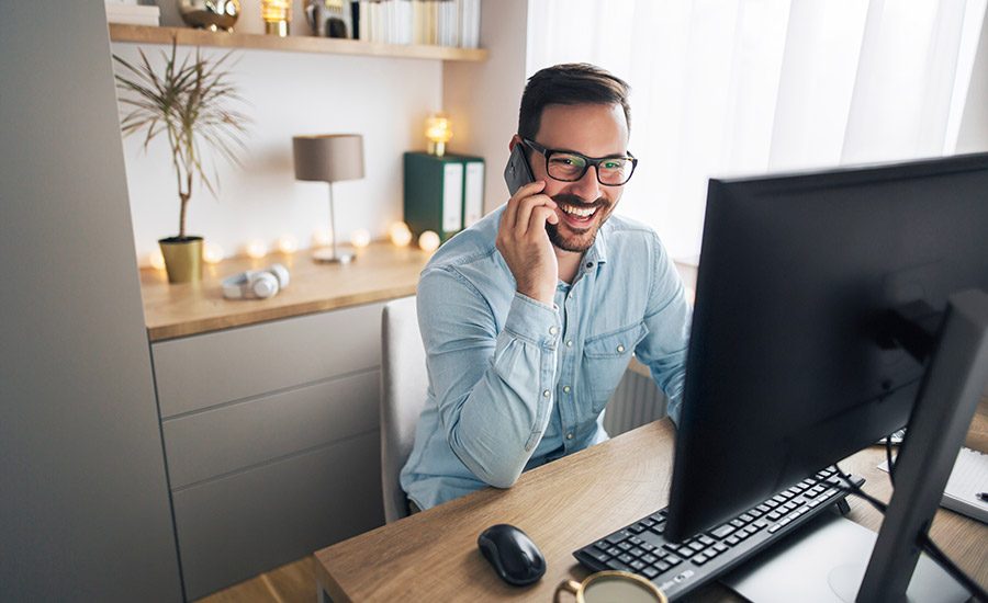 Man using his VoIP solution at a home office