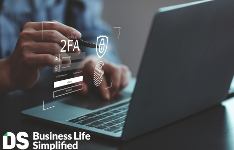 Person on phone and computer completing 2FA