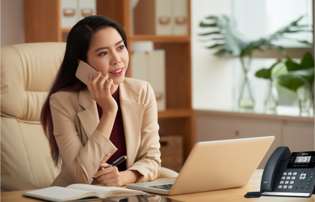 Woman with soft and desk phone