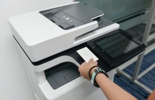 Person using ID badge for print authentication