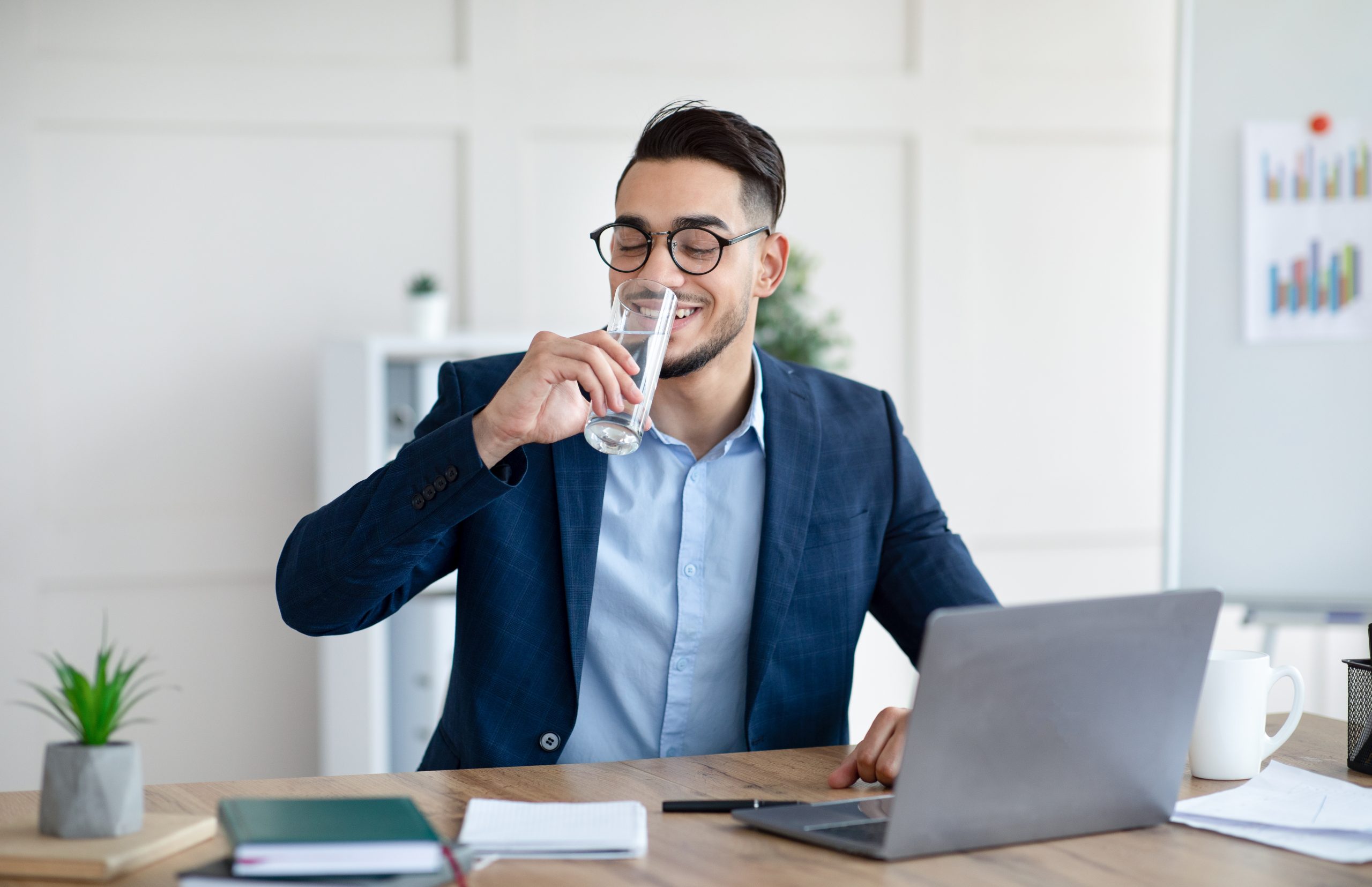 Man drinking water in office